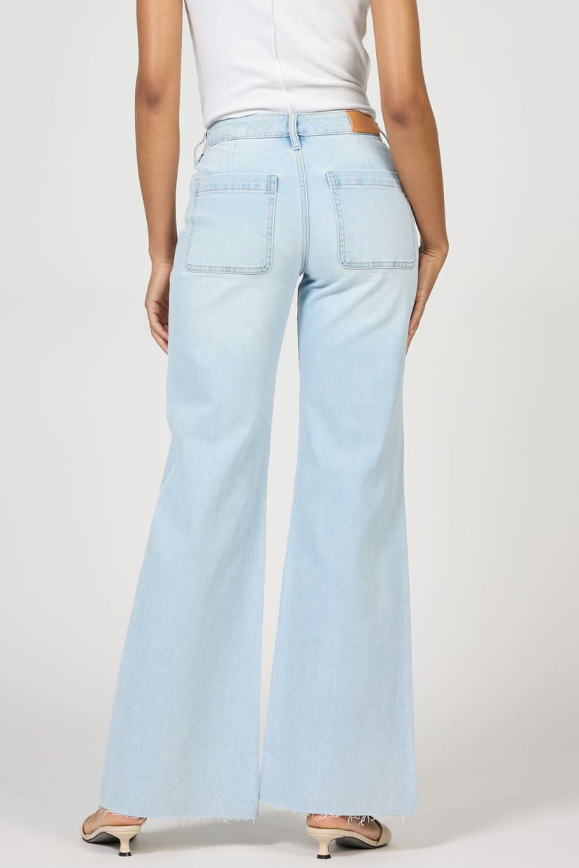 Light blue jeans worn by a person on a white background
