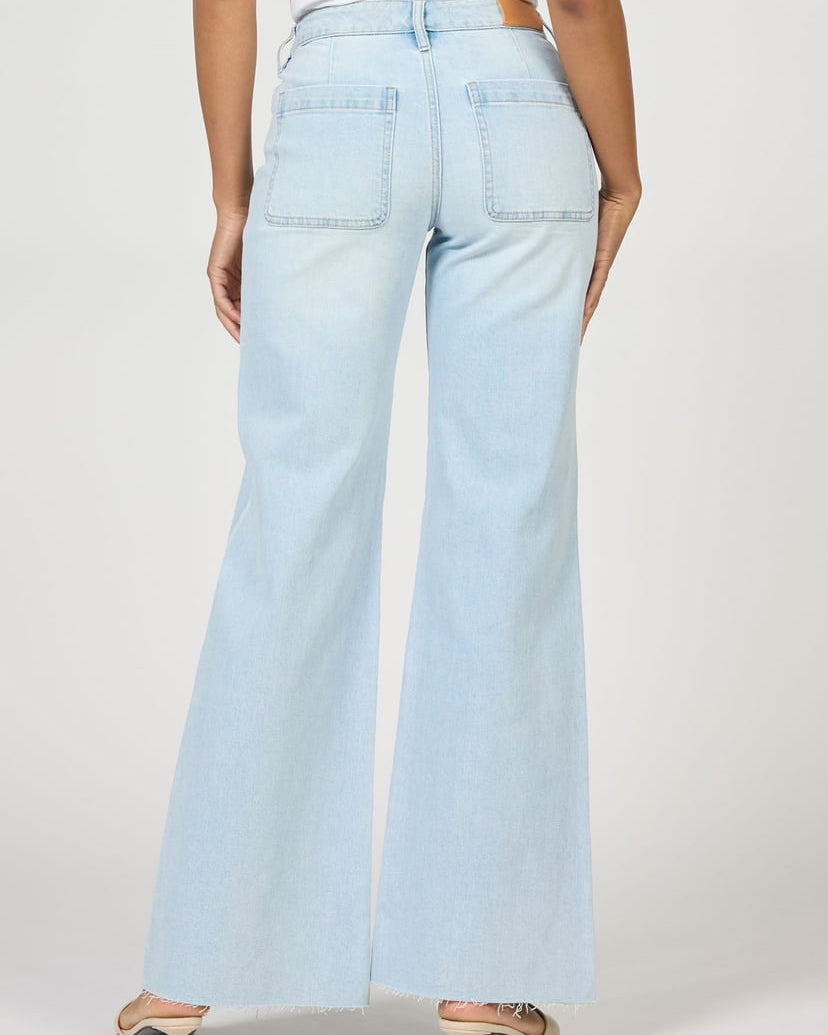 Light blue jeans worn by a person on a white background