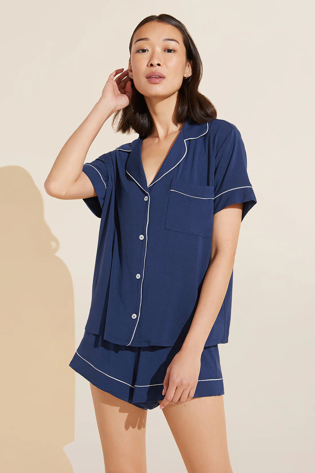 Model wearing Eberjey Gisele Relaxed Short Pj Set in Navy Blue/White on a yellow background
