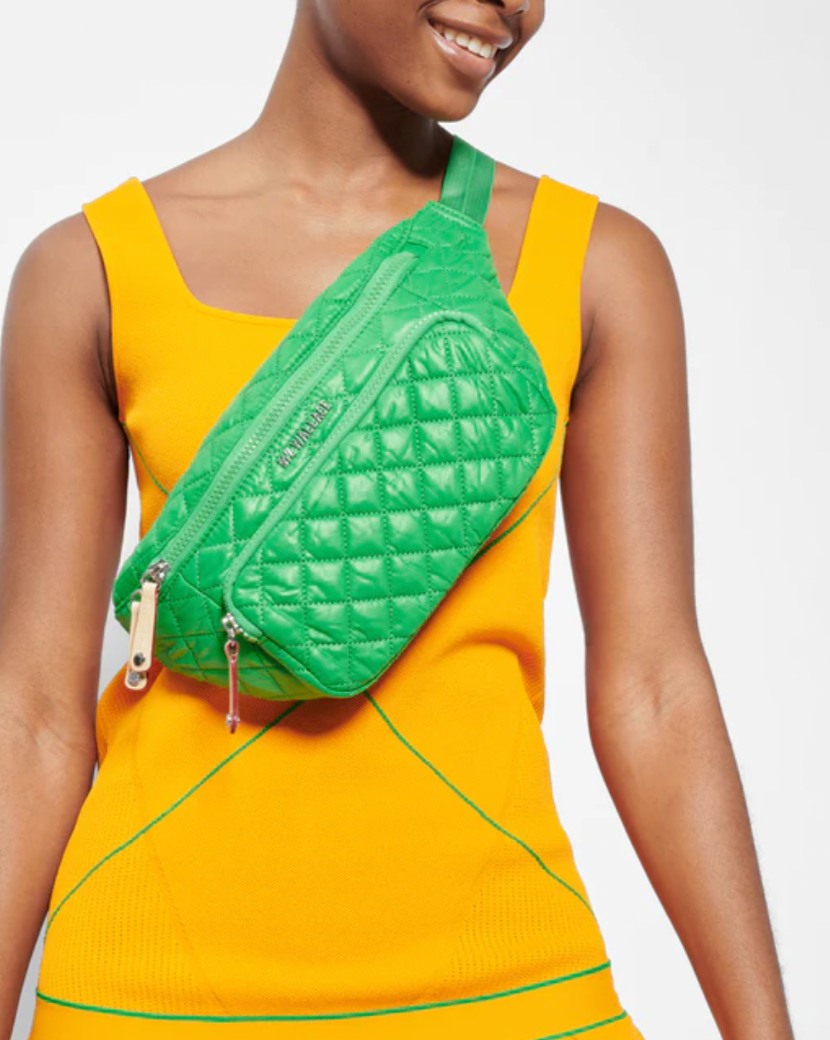 Model wearing MZ Wallace Grass Small Metro Sling Bag wearing yellow dress on a white background