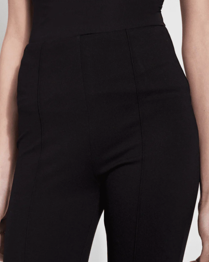 Black pants worn by a person on a light gray background