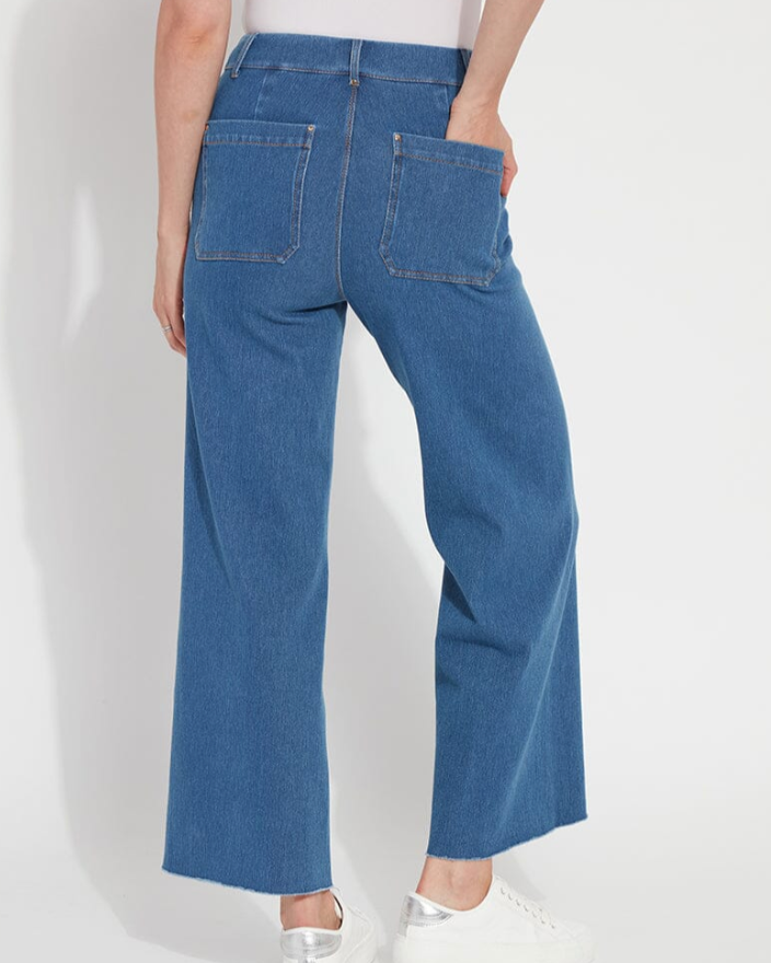 Person wearing blue jeans on a white background