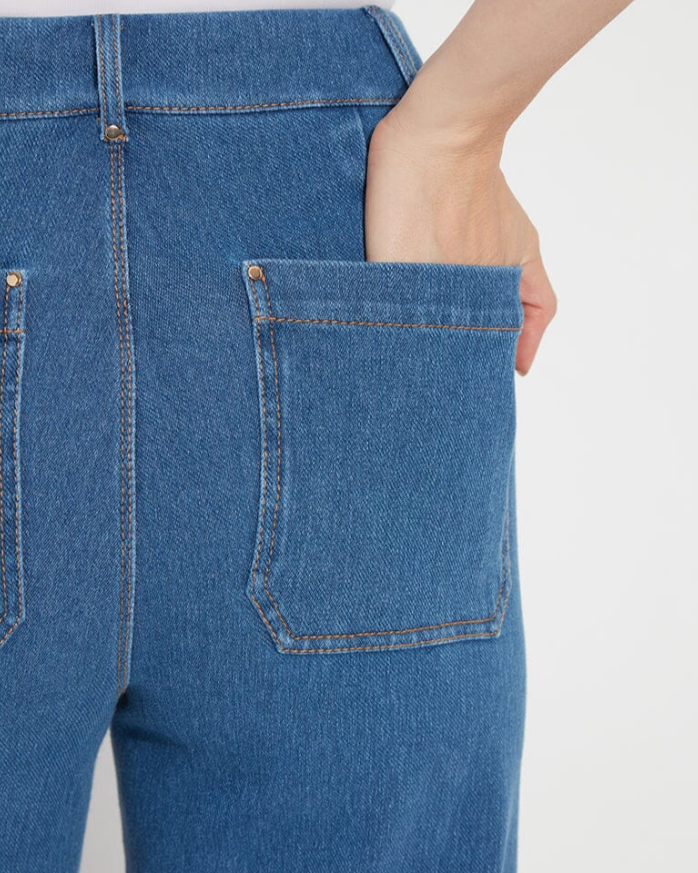 Model wearing blue jeans on white background