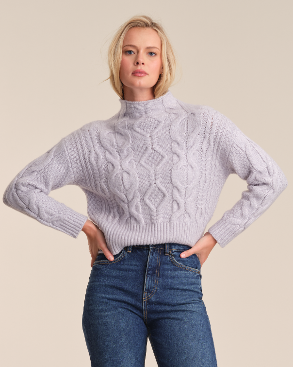 Model is wearing 525 America REBA CABLE FUNNEL NECK PULLOVER in color ARCTIC ICE
