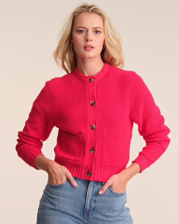 Model is wearing 525 America PALMER CREW NECK CARDIGAN in color CHERRY RED