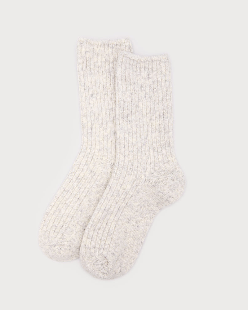 Pair of white textured socks on a light gray background