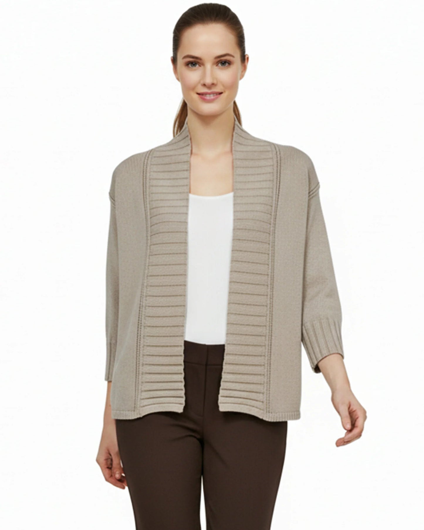 Woman wearing a beige ribbed knit cardigan over a white top and brown pants on a white background