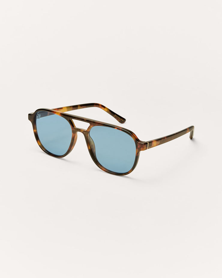 Sunglasses with tortoiseshell frame and blue lenses on a white background