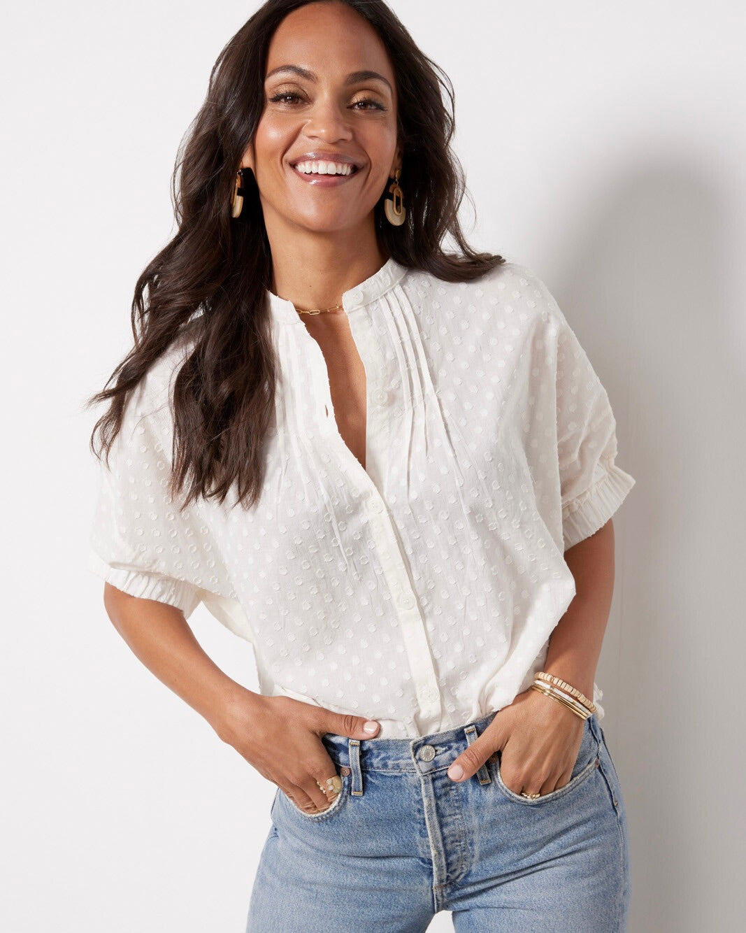 Model wearing Emerson Fry Mandarin Collar Top in Salt Swiss Dot white color wearing jeans on a white background