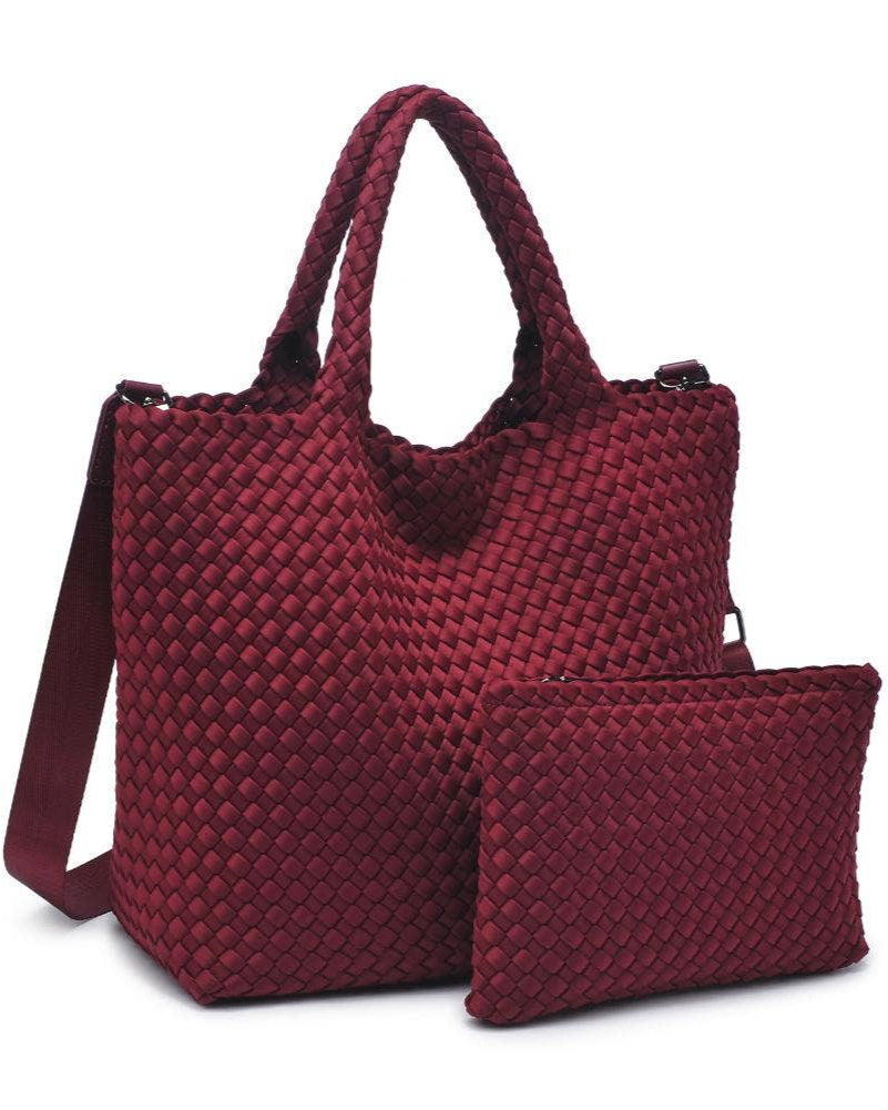 Red woven handbag with matching pouch on a white background