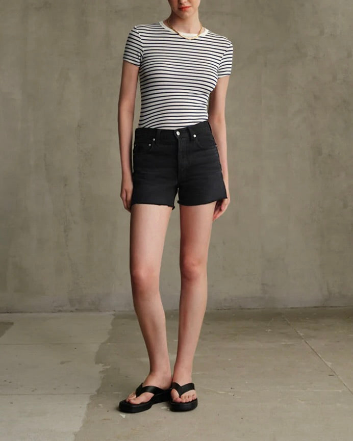 Model is wearing Edwin Sawyer Boyfriend Short in Carbon Black on a grey background.