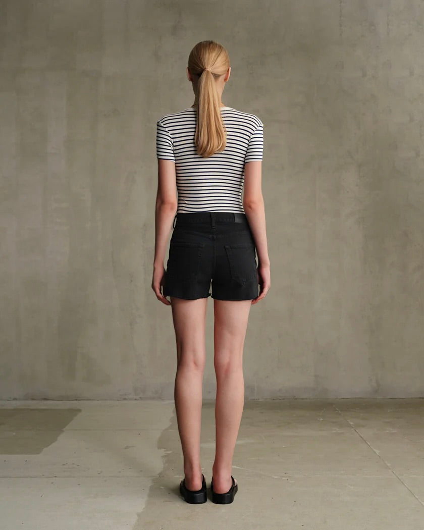 Model is wearing Edwin Sawyer Boyfriend short in Carbon Black on a grey background.