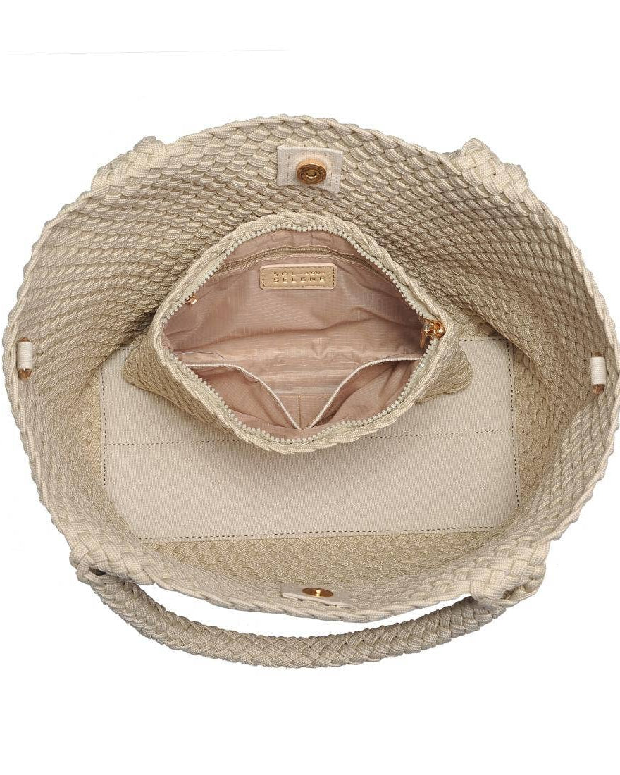 Beige woven handbag with open top showing interior on a white background