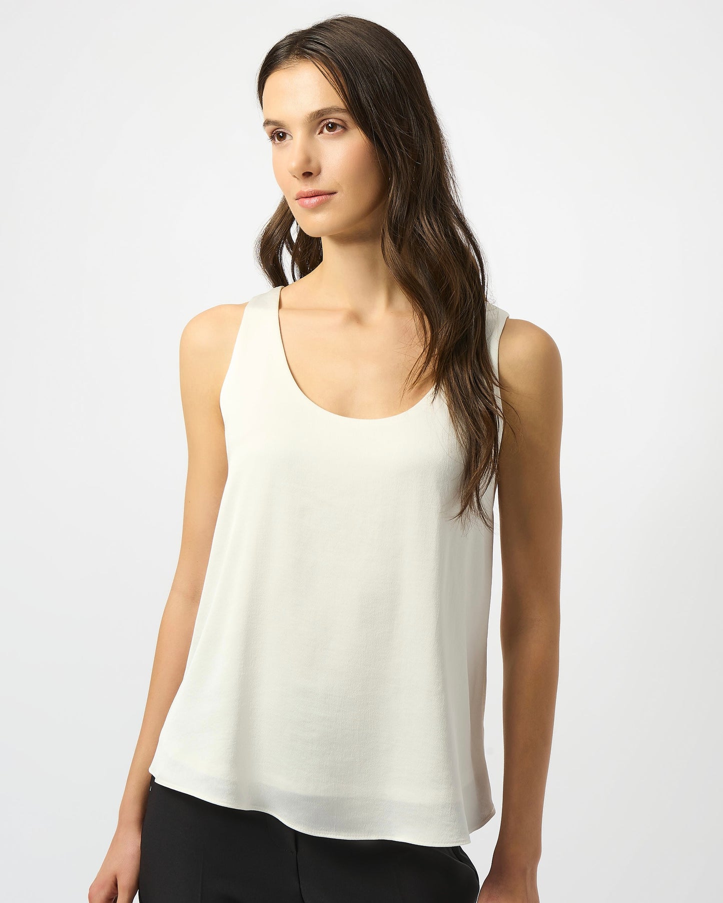 Model is wearing Joseph Ribkoff Recycled Hammered Satin Sleeveless Top in winter white on a white background