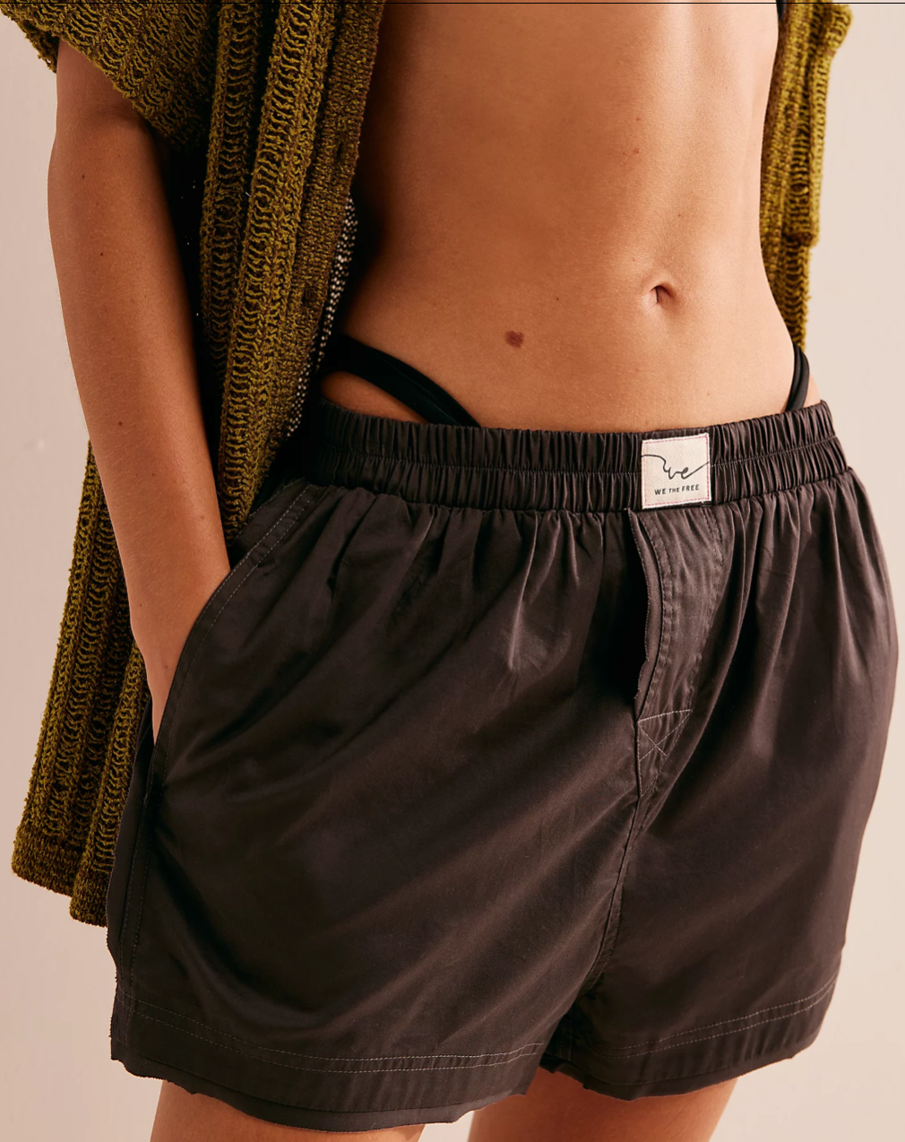 Front view of a model wearing the Free People We The Free Day to Day Solid Boxers, standing in front of a white wall.