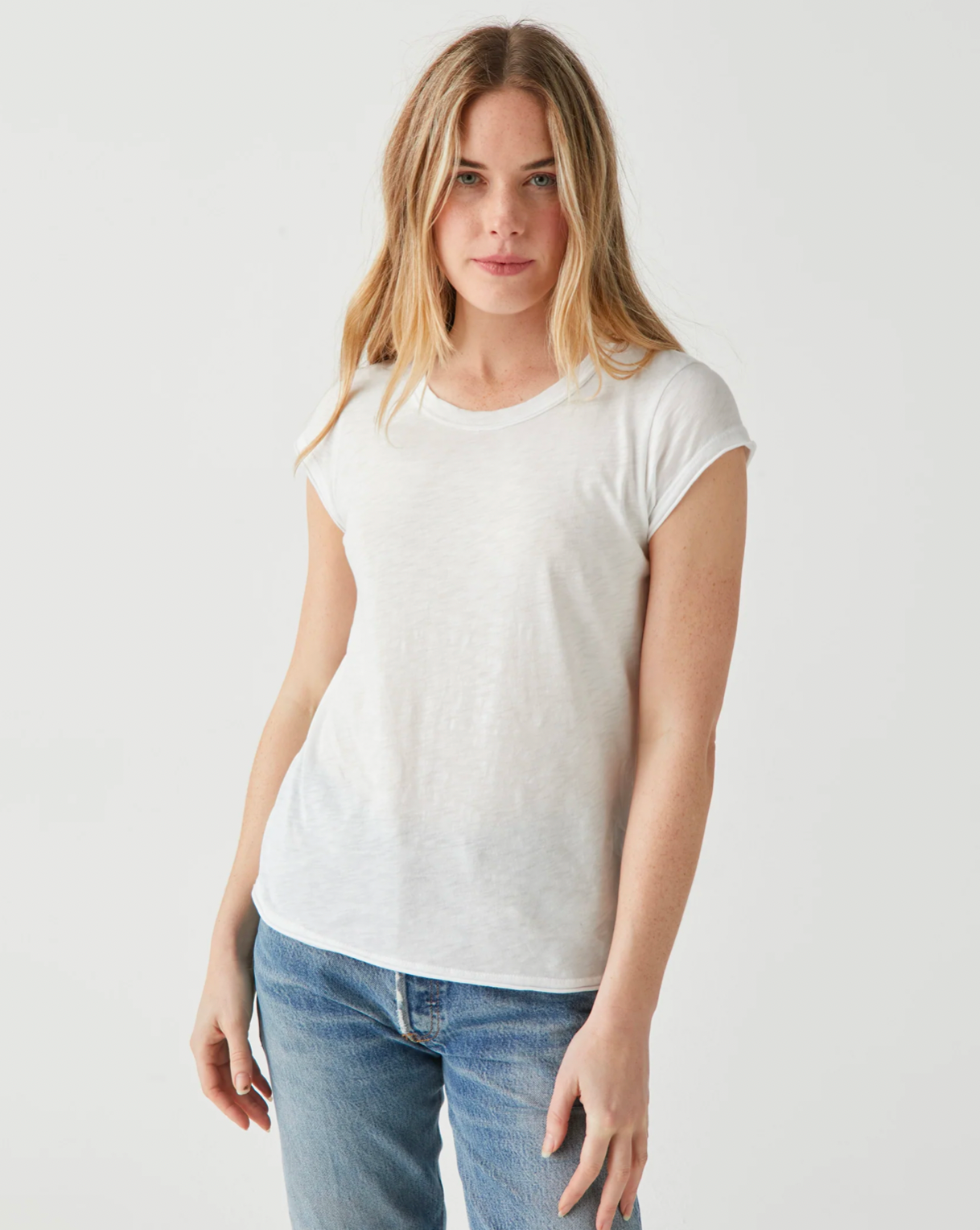 Model wearing Michael Stars White Trudy Crew Tee wearing jeans on a white background