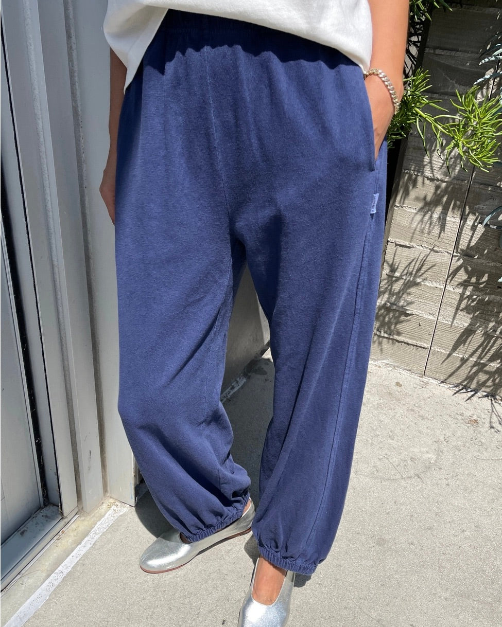 Model wearing the Le Bon Shoppe balloon pant in midnight, standing outside with one hand in their pocket