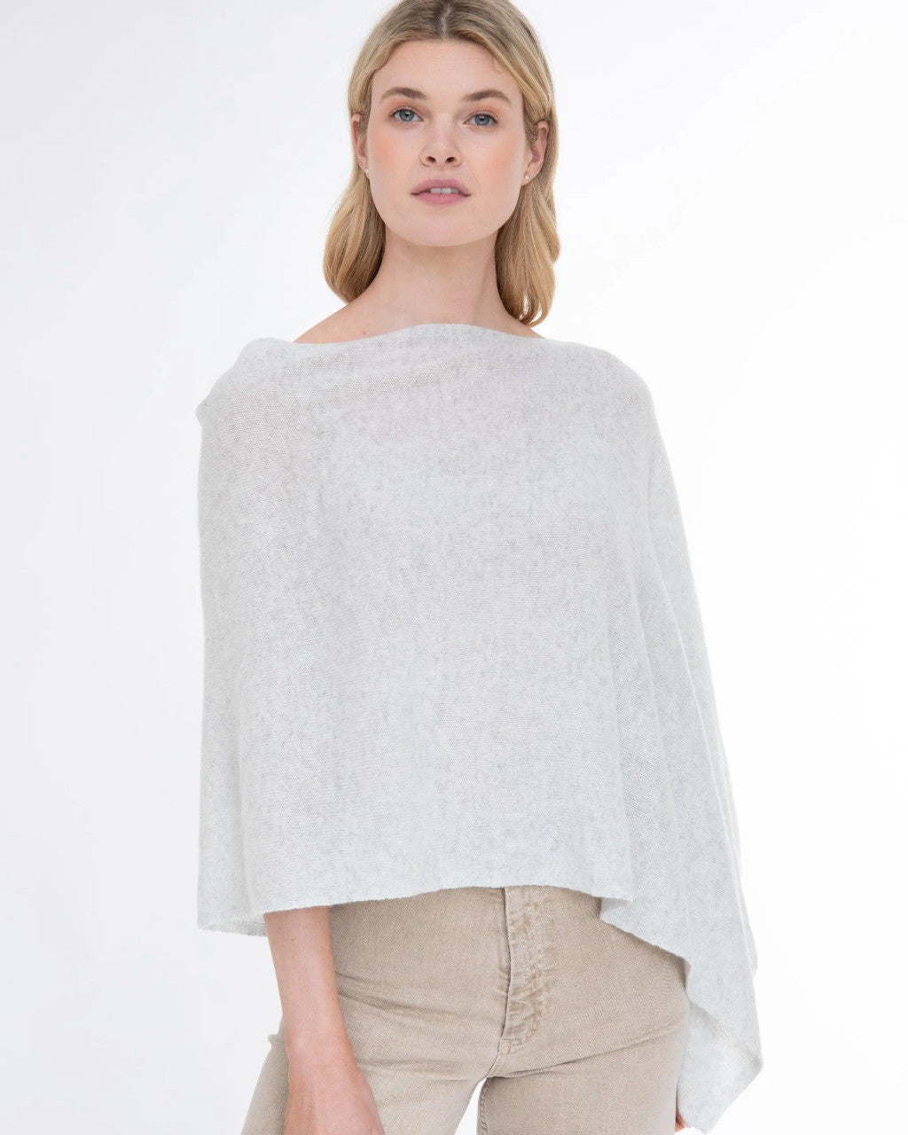 Woman wearing the Alashan Cashmere 100% Cashmere Dress Topper in Cloud against a white background