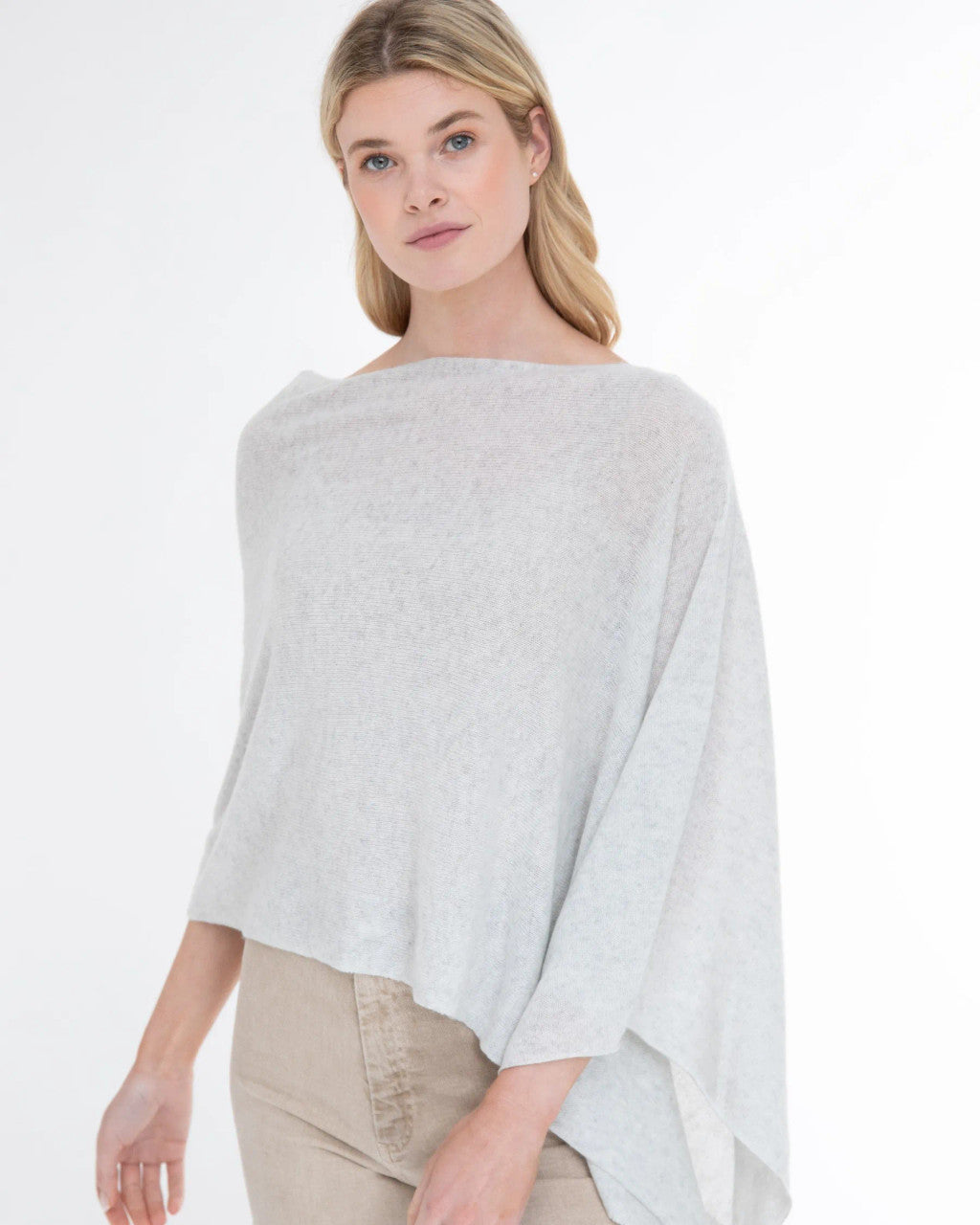 Woman wearing the Alashan Cashmere 100% Cashmere Dress Topper in Cloud against a white background