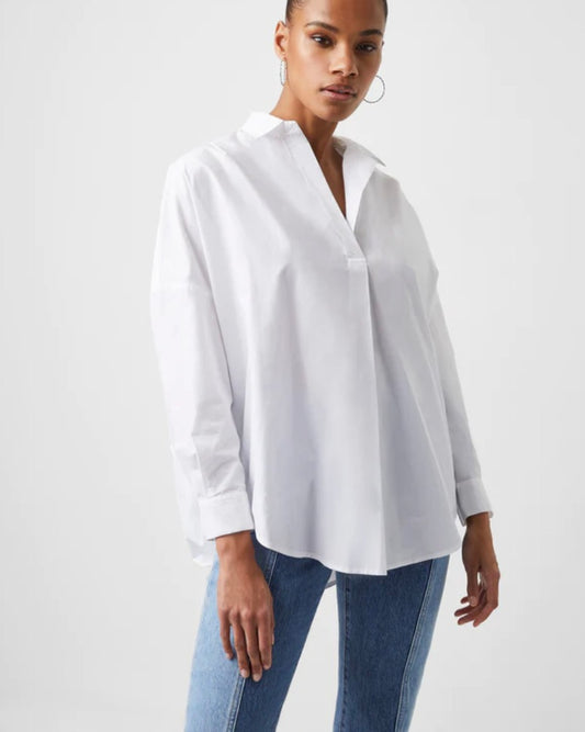 Model wearing French Connection Rhodes Poplin Popover Shirt in Linen white wearing jeans on a white background 