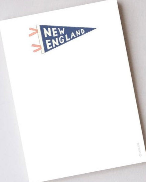 A white notepad with a 'New England' pennant design on the cover, indicating it is 5 inches by 7 inches with 100 sheets.