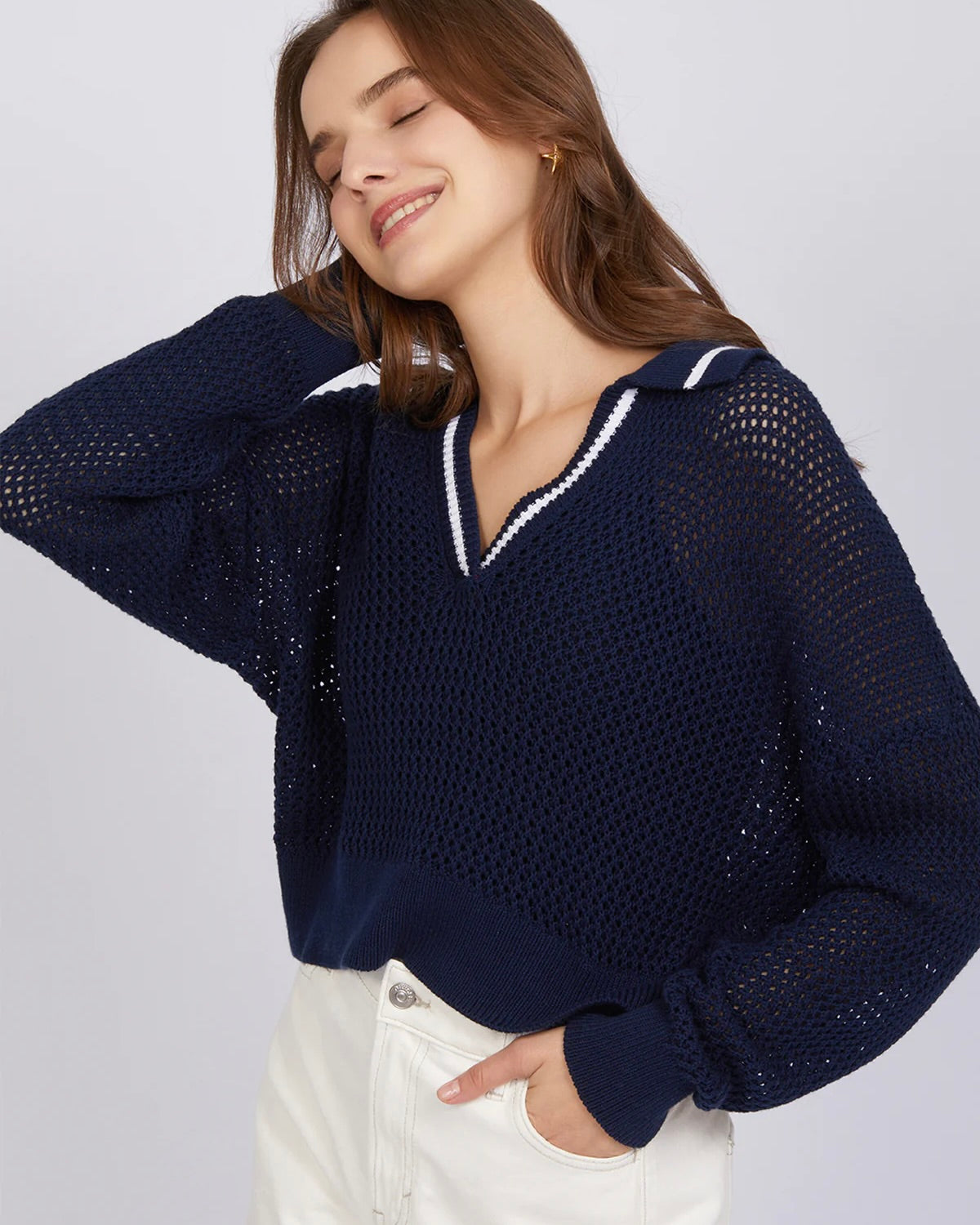 Model wearing 525 America Cara Tipping Navy Polo Pullover sweater wearing white shorts on a white background