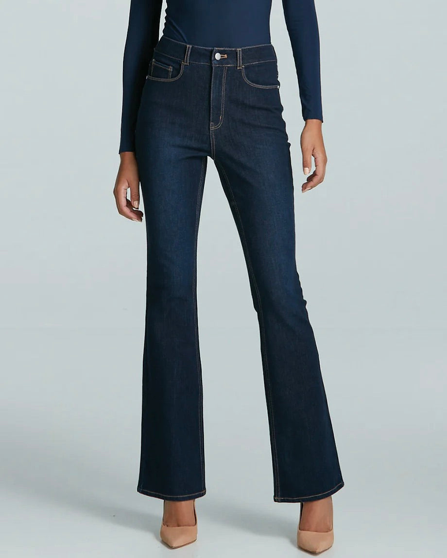 Model wearing commando do it all denim flared jean in dark indigo wearing tan shoes and a blue shirt on a white background
