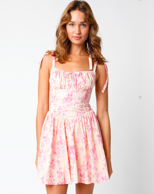 Model wearing Olivaceous Tie Strap Blush Pink Floral Dress on a white background