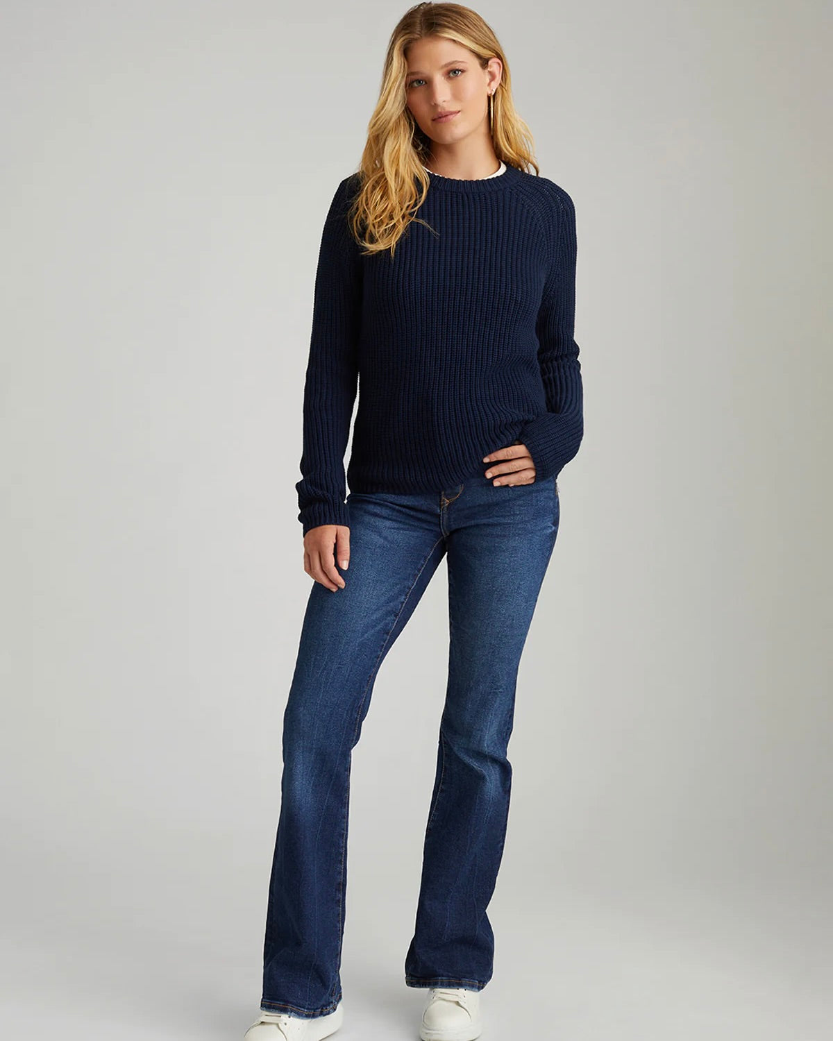 Model wearing 525 America Jane Pullover Sweater in navy wearing jeans on a white background