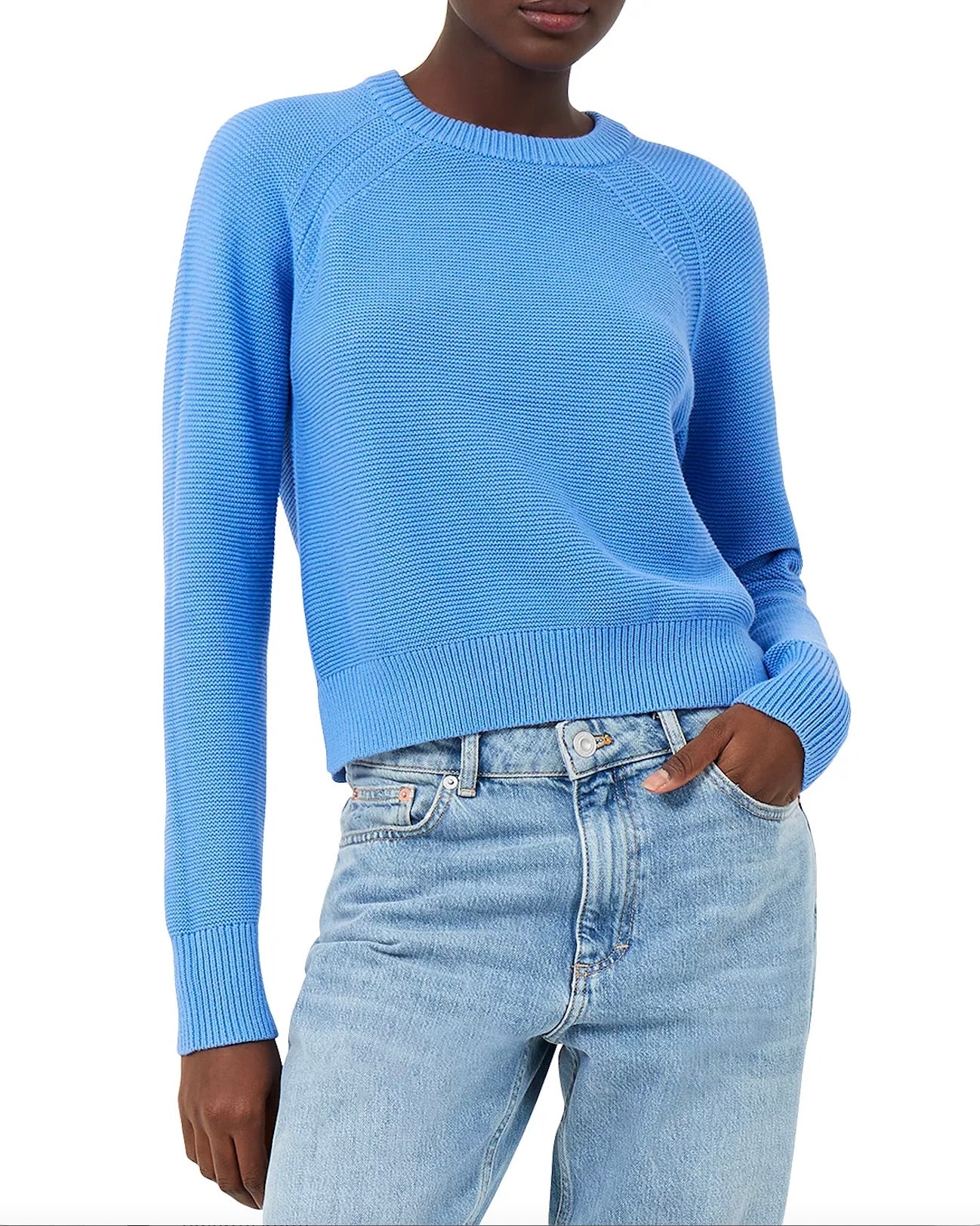 Model wearing French Connection crewneck jumper in marine blue wearing jeans on a white background