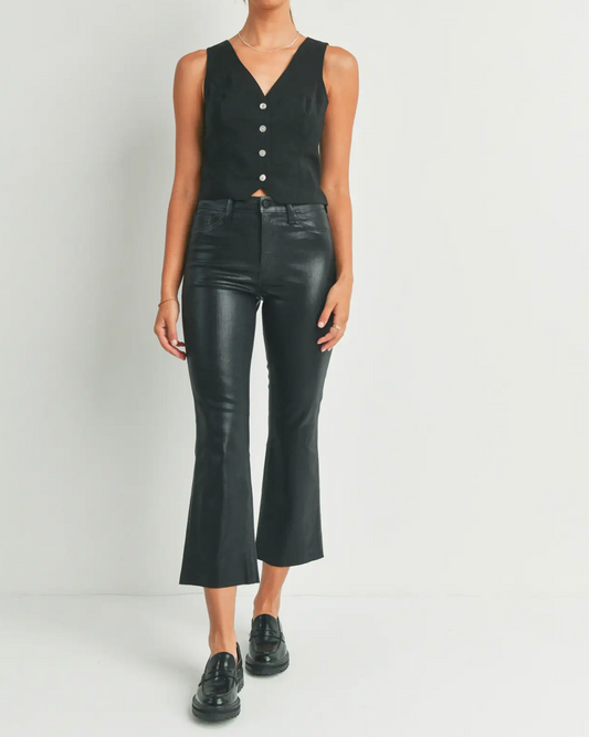 Model wearing Just Black waxed cropped kick flare pants wearing black shoes and a black vest on a white background