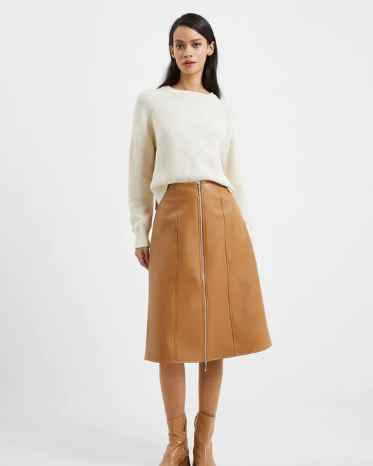 Model wearing French Connection Claudia PU Skirt in camel wearing white sweater on a white background