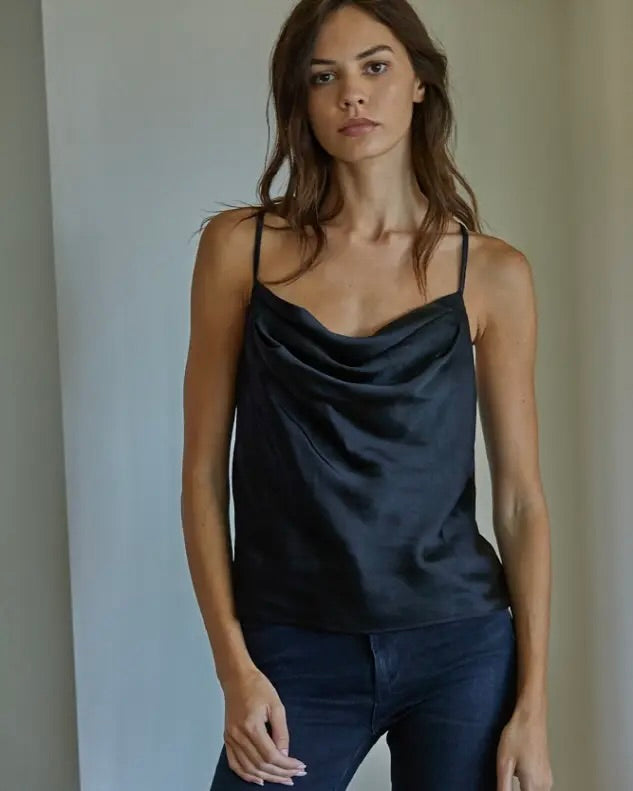 Model wearing By Together Satin Camisole in black wearing jeans on a white background