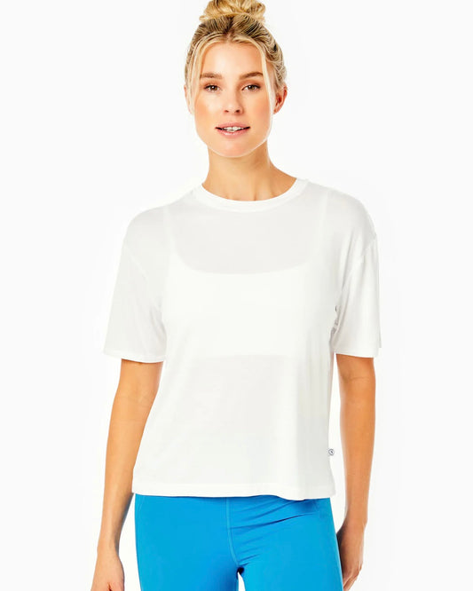 Model wearing Addison Bay white classic short sleeve shirt with blue pants on a white background