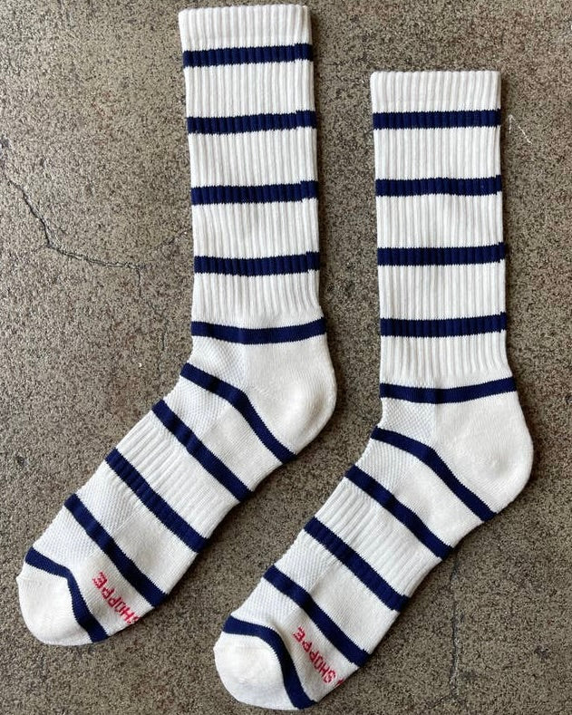Image of LE BON SHOPPE extended striped boyfriend socks-sailor blue stripe on a brown background