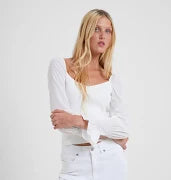 Model wearing French Connection Maia Krista Crepe Mix Jumper in Summer White wearing white pants on a white background