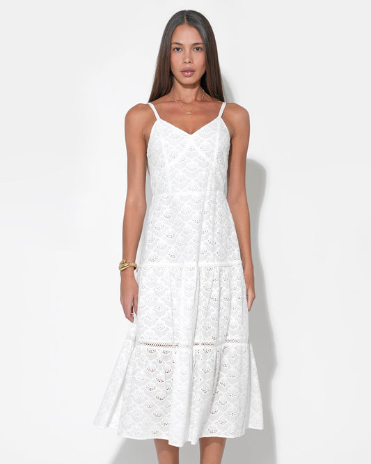 Model wearing the Lina Tiered Strappy Cotton Eyelet Embroidered Midi Dress in front of a white background.