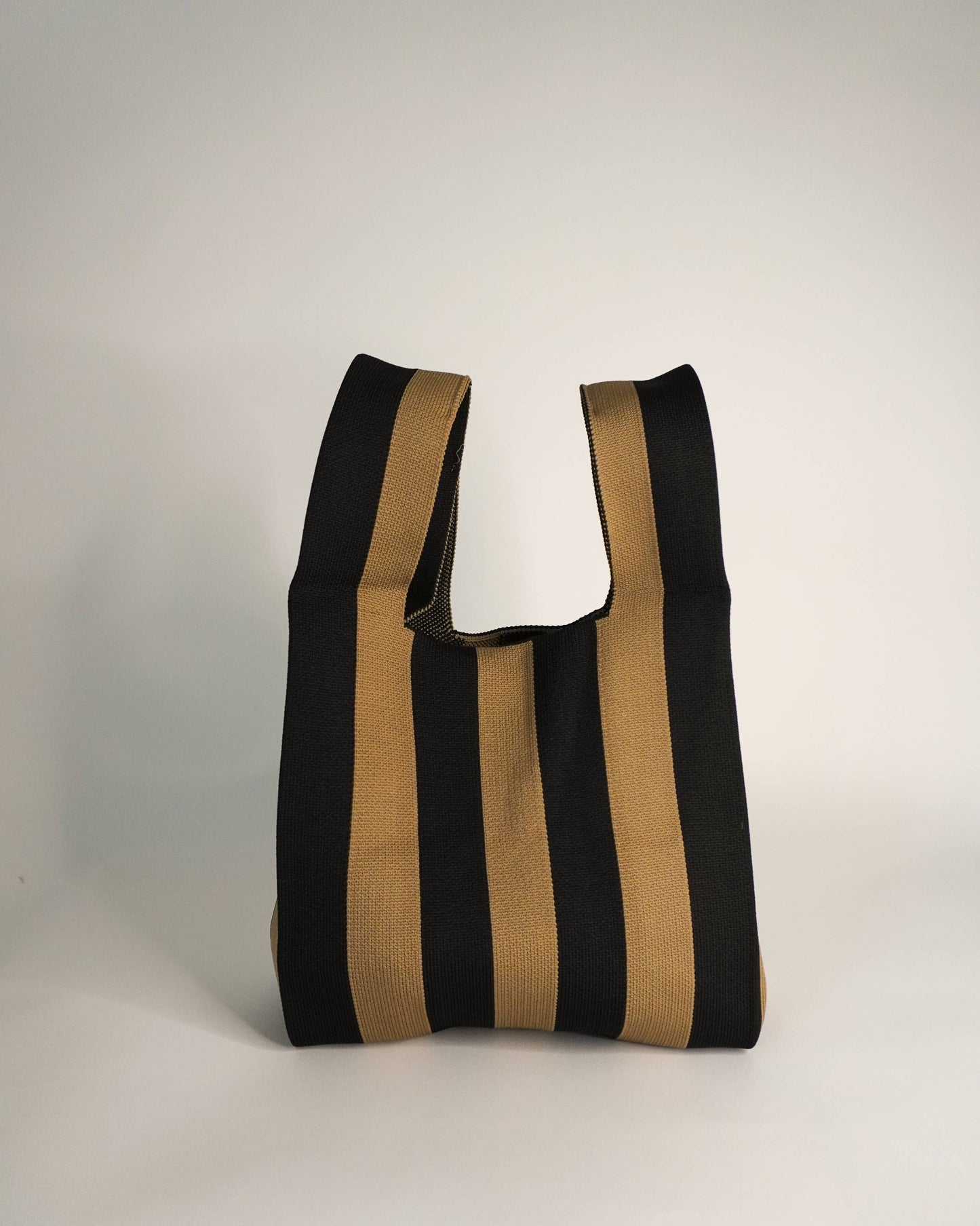 Black and beige striped tote bag on a white background