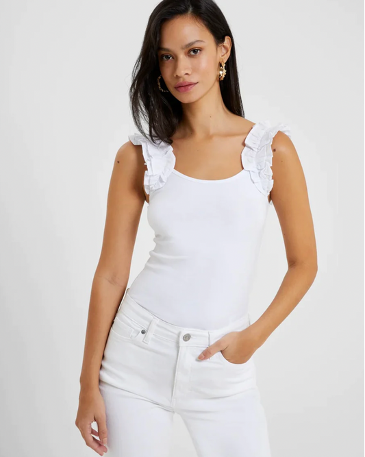 Model Wearing French Connection White Rallie Cotton Frill Sleeveless Tee Wearing White Pants On A White Background