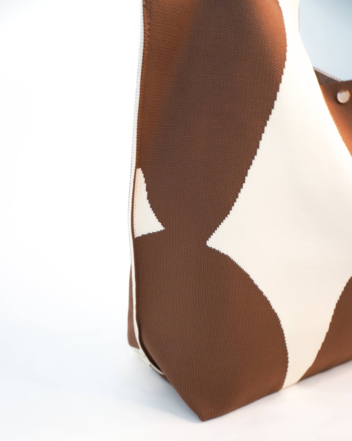 Close-up of a brown and beige patterned fabric with star design on a white background