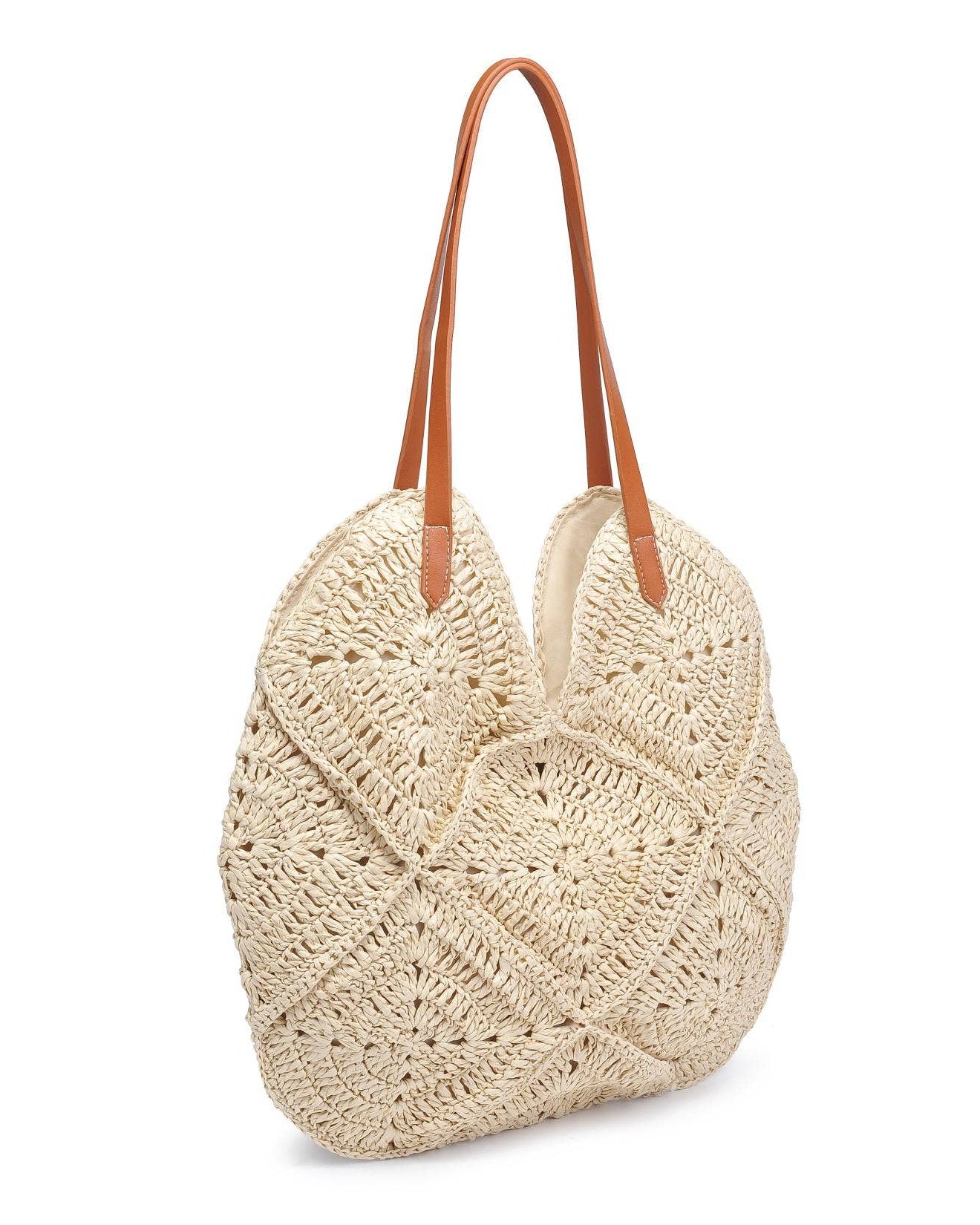 Beige woven handbag with brown leather straps on a white background