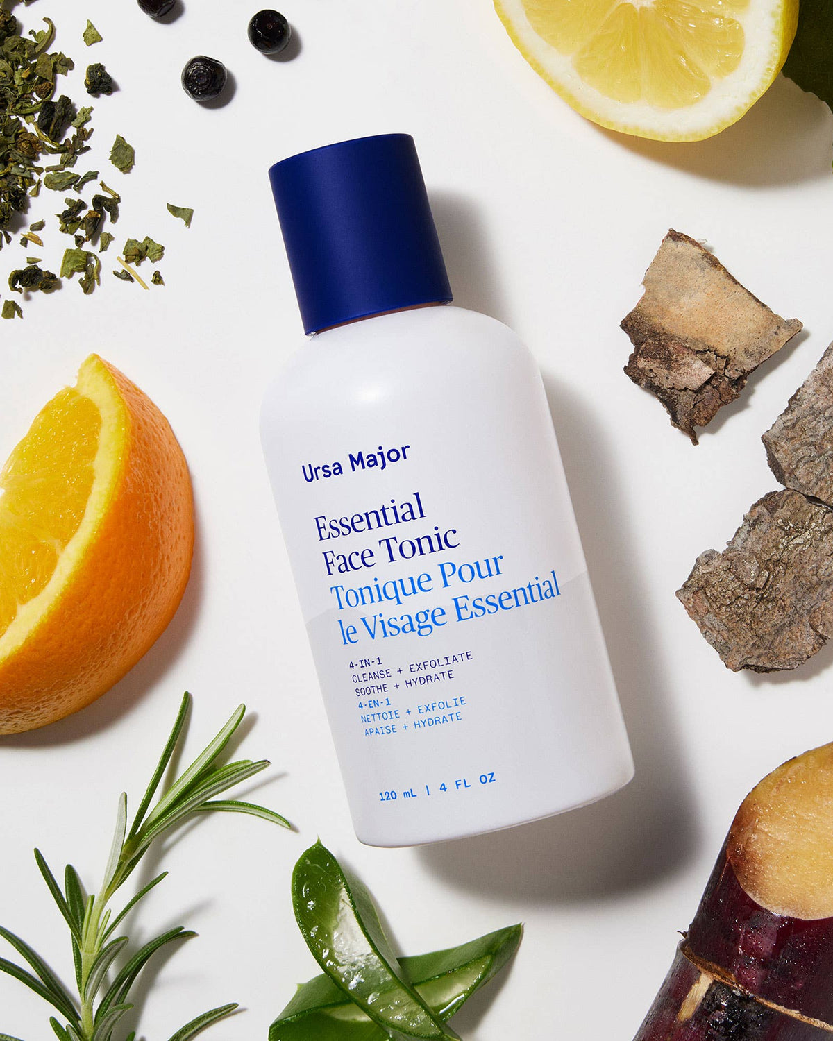 Ursa Major Essential Face Tonic bottle surrounded by natural elements on a white background