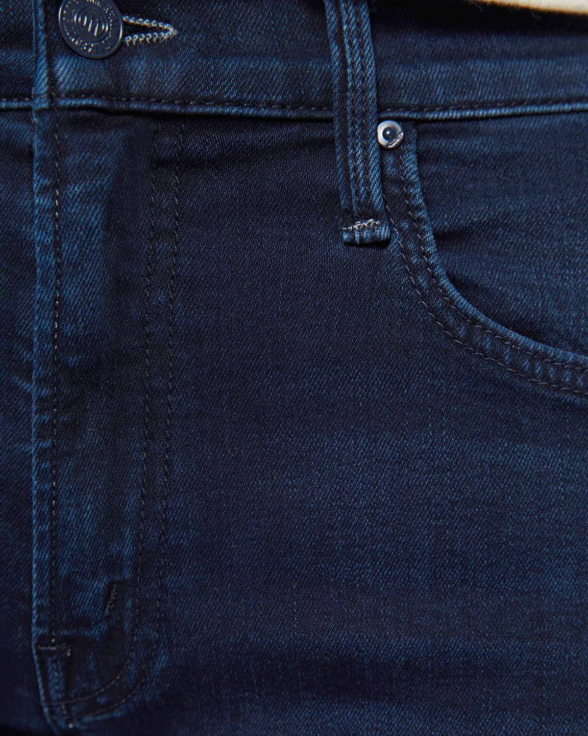 Close-up of dark blue denim fabric with stitching details