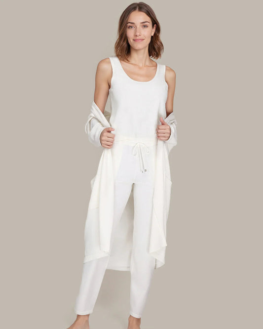 Woman wearing a white outfit on a beige background