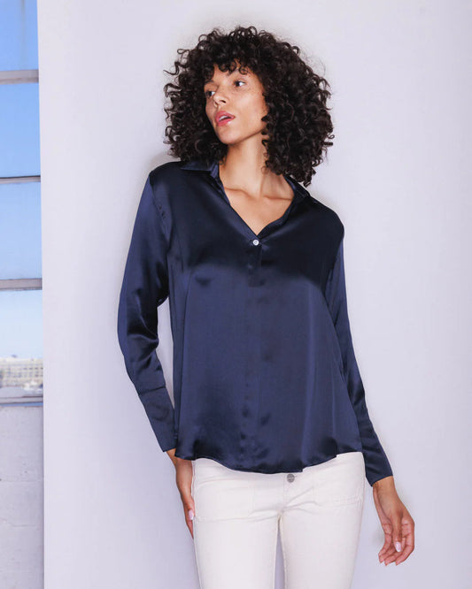 Woman wearing the Daria French Cuff blouse in Midnight against a white background.