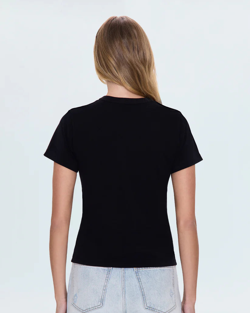 Person wearing a black t-shirt and light blue jeans on a white background