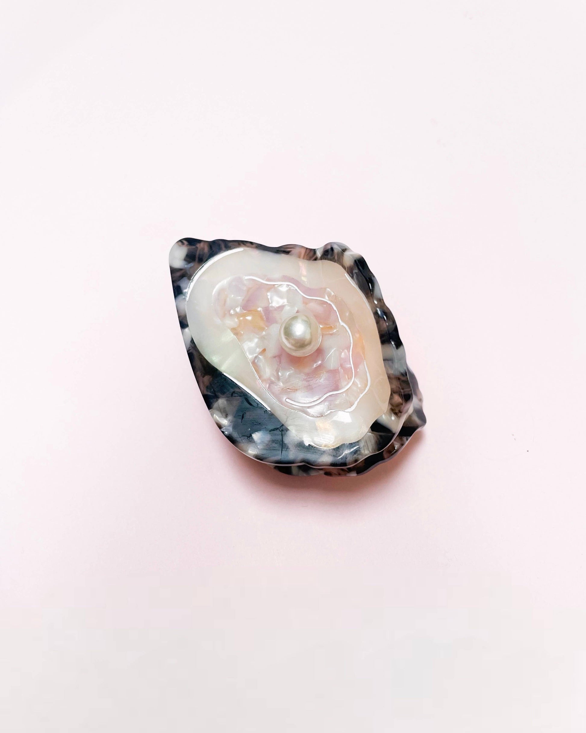 Front view of the Line&Co oyster claw clip on a pink background