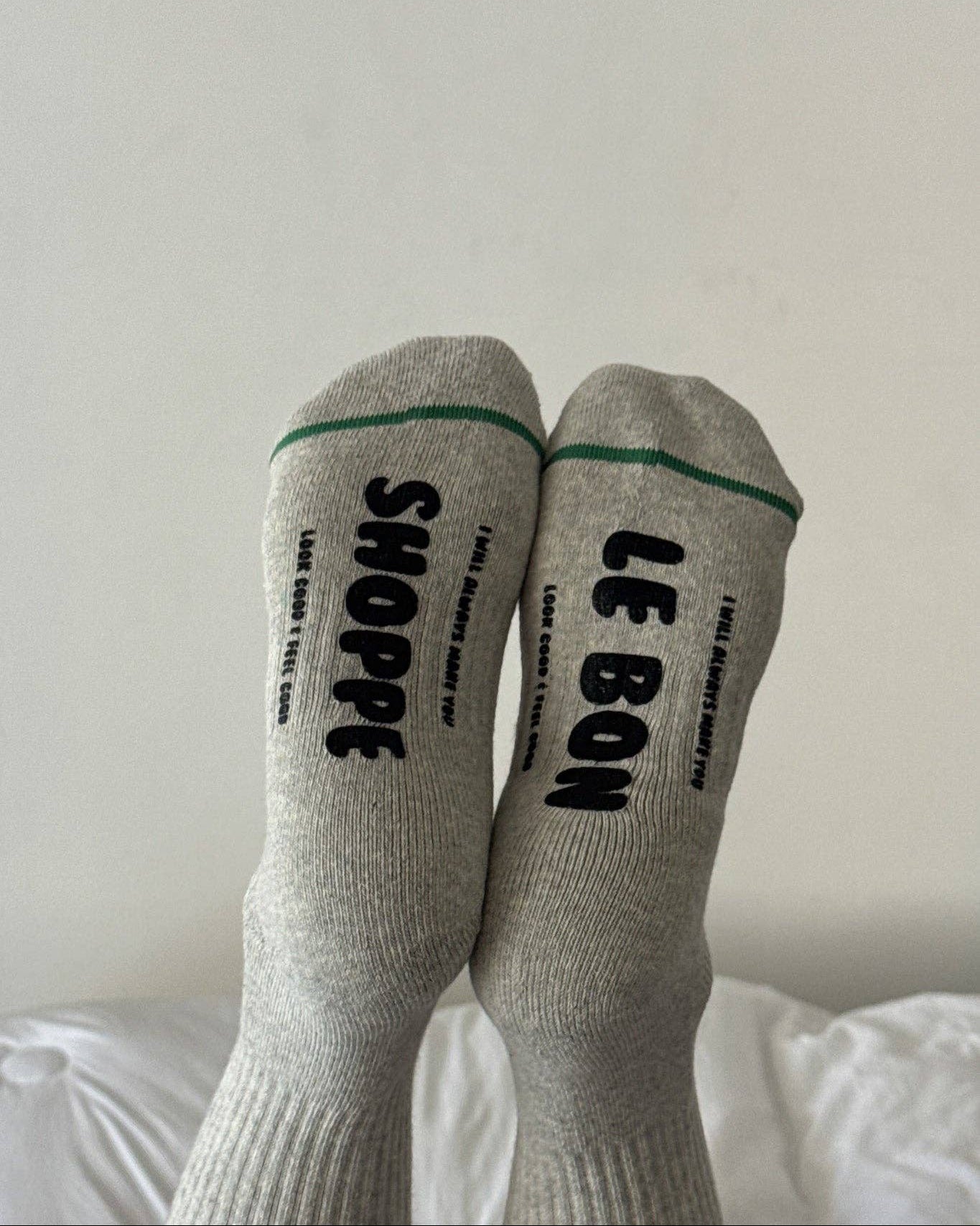 Gray socks with black text on a white background