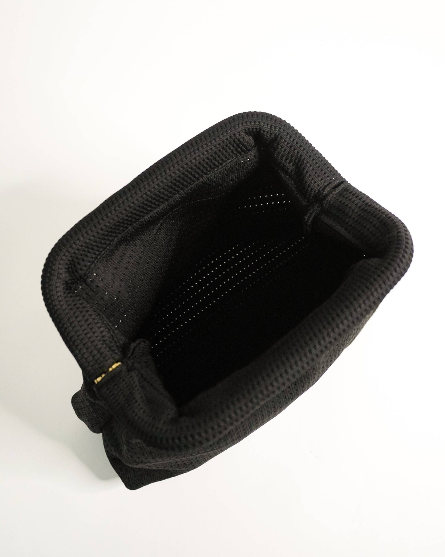 Black plastic tray with multiple small cups on a white background