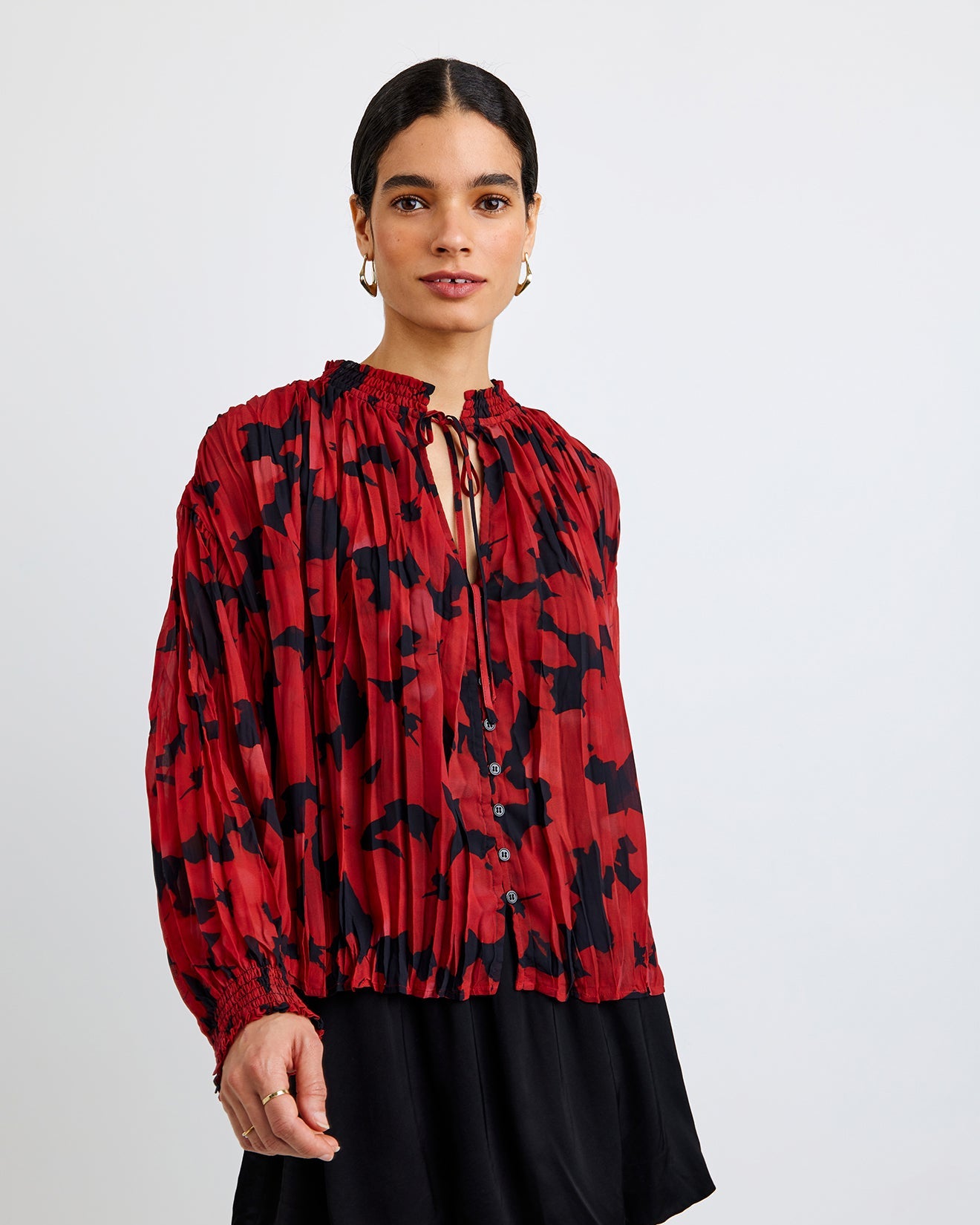Bella Dahl L/S PLEATED SMOCKED BUTTON DOWN on a model with a black skirt in front of a white background